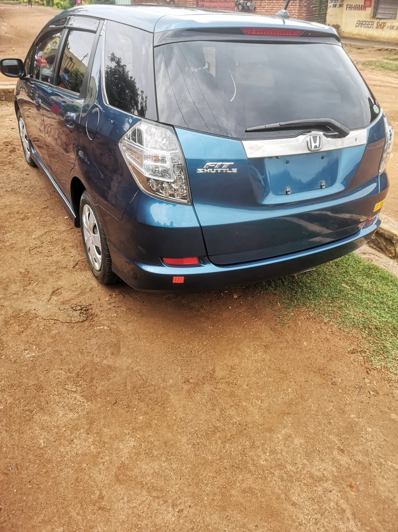 UNREGISTERED HONDA FIT SHUTTLE 2013 MODEL FOR SALE . Price mk16 million *Back motor  *Fog light   *1.490cc *millege 60k *Blue colour *Body Type wagon. Lilongwe  Call 0996496043
